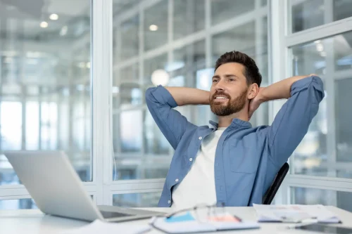 worker-stress-free-behind-desk-hands-behind-head